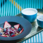 Berry dessert bowl (possibly panna cotta, yogurt, or cream dessert with berries)