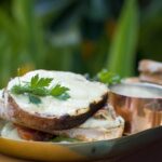 Open-faced toast sandwich (likely egg salad or creamy herb spread on bread)