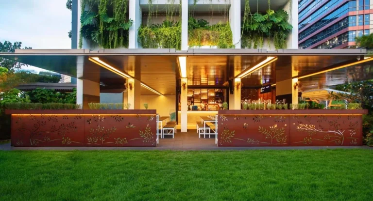 Modern outdoor patio with greenery at a garden-style Halal-certified café in Singapore.