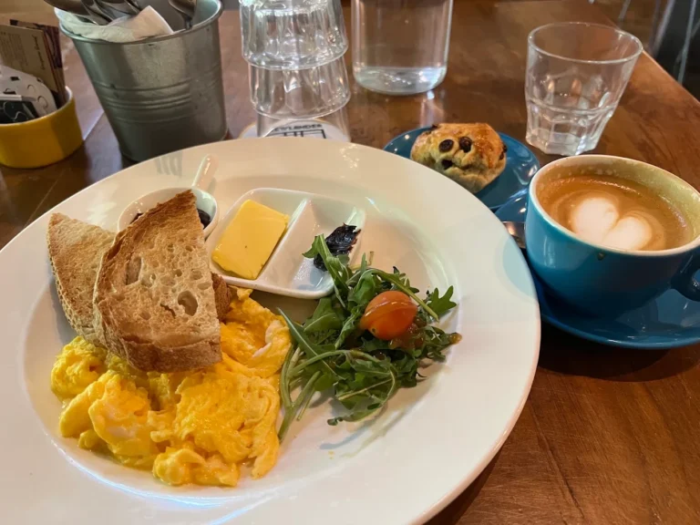 Latte art with scrambled eggs and toast served at a Hidden coffee gem in Singapore.