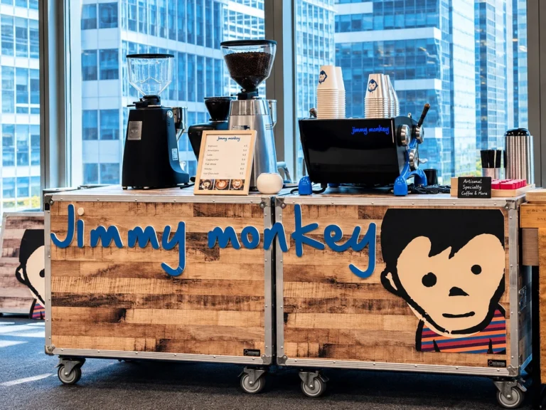 Branded wooden mobile coffee bar setup for events during mobile coffee cart hire in Singapore.